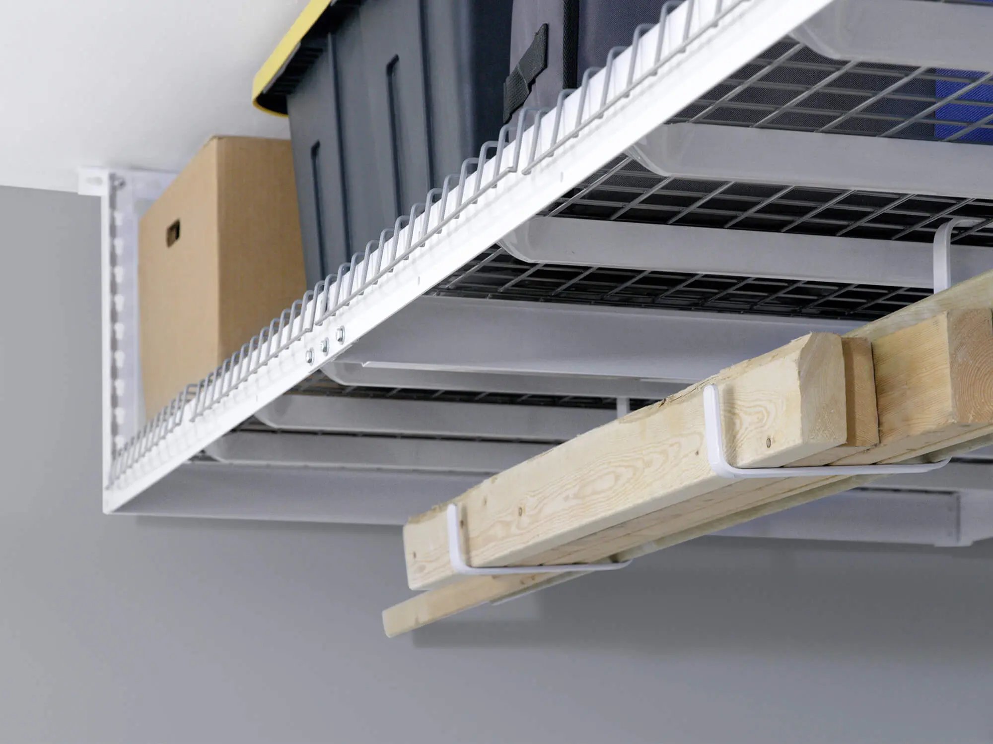 ceiling mounted storage rack with lumber hanging below